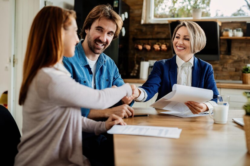 Happy Real Estate Agent Greeting Young Couple Meeting Their Home Women Are Shaking Hands 637285 5792