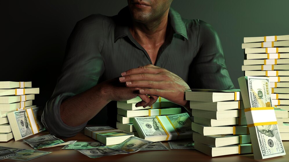 Man Sitting Front Table Full Stacks Us Dollar Notes Dark Background 584365 54